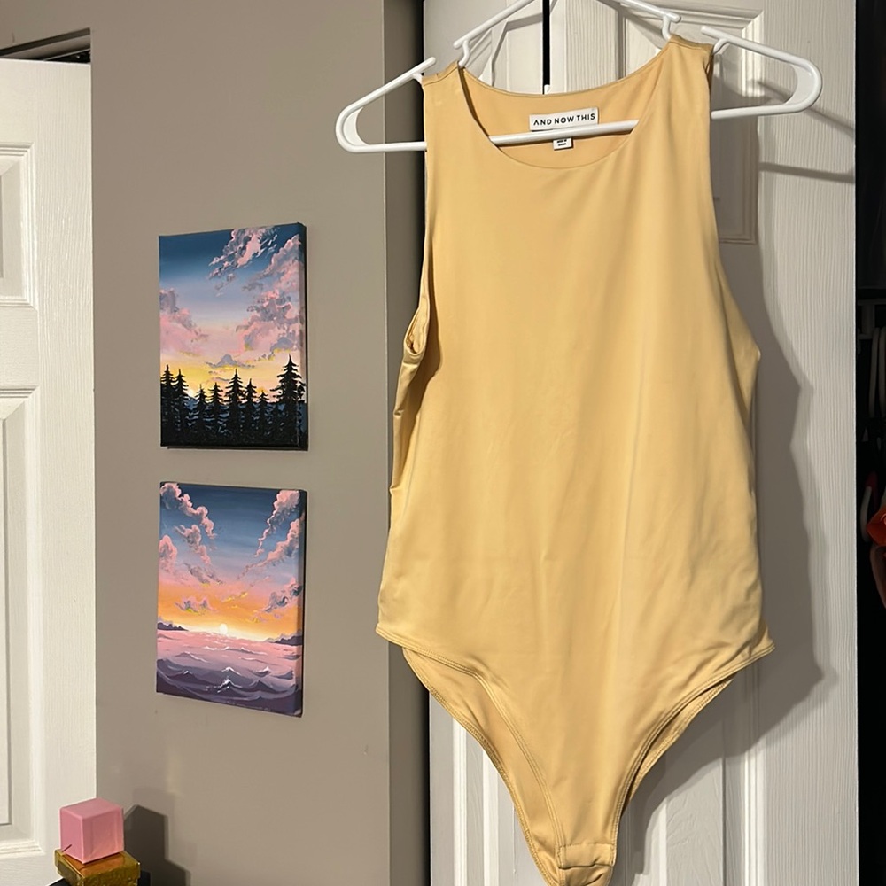 And Now This yellowish gold bodysuit